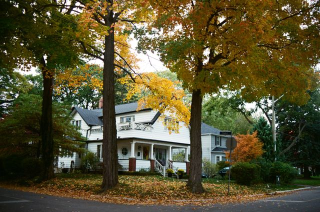 white house amidst vibrant fall foliage